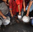 Niños palestinos hacen cola frente a un comedor social en el campo de refugiados de Nuseirat, en el centro de la Franja de Gaza. 