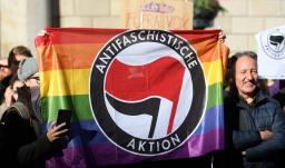 Contramanifestantes sostienen una bandera del partido antifascista Aktion en Barcelona el 12 de enero de 2020 durante una concentración de simpatizantes del partido español de extrema derecha VOX para protestar contra el nuevo gobierno de coalición del presidente del Gobierno español.