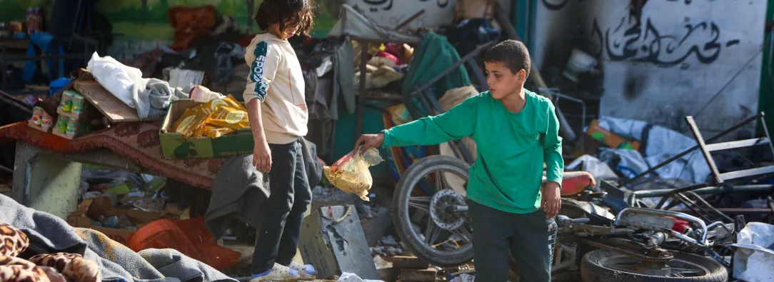 Niños sobre los escombros de la escuela, al verla destruída