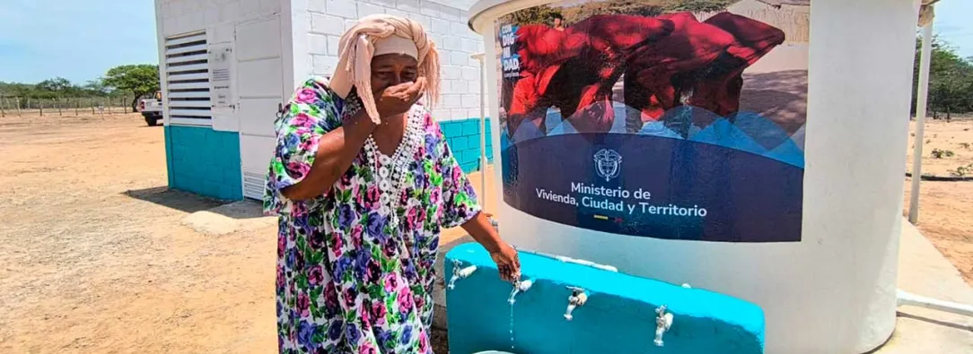 Mujer de la comunidad de Manaure utilizando el sistema de agua potable entregado por el Ministerio de Vivienda
