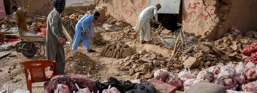 Los comerciantes de Afganistán buscan los restos de sus tiendas dañadas a lo largo de una carretera, tras un terremoto en Tang-e Tashkurgan, en el distrito de Khulm, provincia de Samangan.