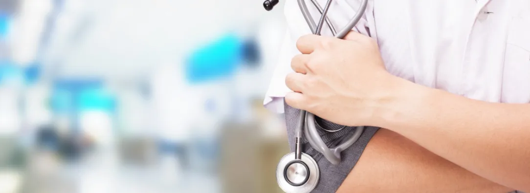 doctor-with-stethoscope-in-the-hands-and-hospital-background-1.jpg